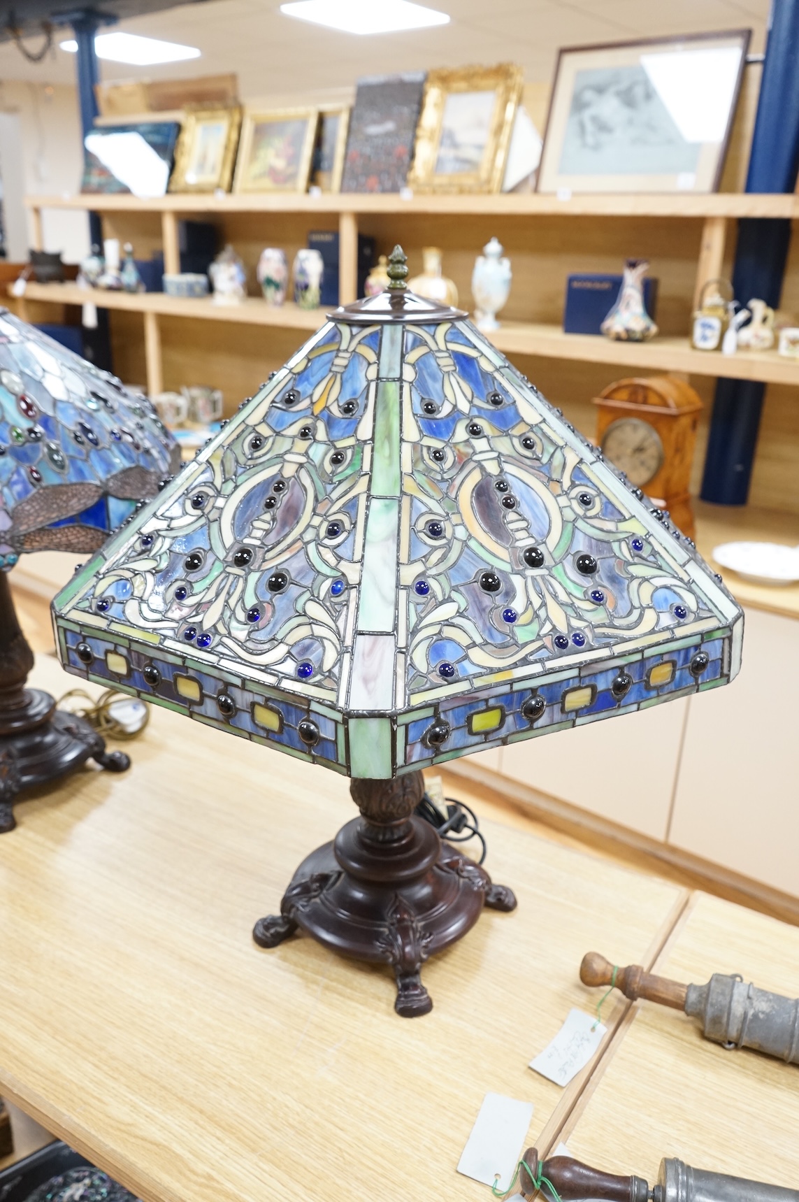 Two Tiffany style table lamps, with ornate glass and metal shades, tallest 72cm high